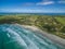 Aerial view of Cape Bridgewater beach, settlement, and wind farm in Victoria, Australia.