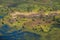 An aerial view capturing the swirling patterns of lush vegetation, water and land in the Okavango Delta, Botswana