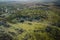 An aerial view capturing the swirling patterns of lush vegetation, water and land in the Okavango Delta, Botswana