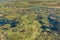 An aerial view capturing the swirling patterns of lush vegetation, water and land in the Okavango Delta, Botswana