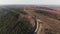 Aerial view of car driving on country road. Cinematic toned. drone shot flying over electrical wires and asphalted road