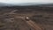 Aerial view car driving off road in Iceland highlands. Drone view 4x4 car hitting dirt road adventurous exploring