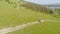 Aerial view of car driving offroad through rural countryside