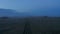 Aerial view car parked in grassy misty countryside in Iceland. Dramatic foggy misty drone of moonscape valley in Iceland