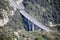 Aerial View Of Car Traffic On A Highway Bridge With Pillars And Freeway Exit