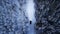Aerial view of a car on winter road in the forest. Aerial photography of snowy forest with car on the road. Aerial photo. Car in m