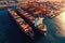 Aerial view of a cargo container ship. Fully loaded container ship against the background of a cargo terminal in a