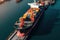 Aerial view of a cargo container ship. Fully loaded container ship against the background of a cargo terminal in a