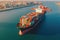 Aerial view of a cargo container ship. Fully loaded container ship against the background of a cargo terminal in a