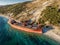 Aerial view of cargo ship run aground on wild coast, shipwreck after storm