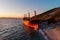 Aerial view of cargo ship run aground on wild coast, shipwreck after storm