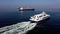 Aerial view of cargo ships and modern sailboat on sea water.