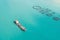 Aerial view cargo tanker moored in the bay, near the farm for growing fish