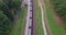 Aerial view of cargo train in field. Freight long train carries with cargo carriages with gravel.