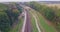 Aerial view of cargo train in field. Freight long train carries with cargo carriages with gravel.