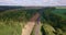 Aerial view of cargo train in field. Freight long train carries with cargo carriages with gravel.