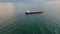 Aerial view cargo vessel sailing ocean to gloomy horizon. Tanker floating sea