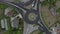 Aerial view of cars passing a roundabout, shooting from a drone in rotation