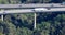 Aerial view of cars and trucks traffic on a highway bridge with pillars