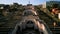 Aerial view of the Cascade Monument, evening sun rays, people walking along the