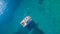 Aerial view of catamaran anchoring on coral reef