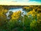 An aerial view of the Catawba river with a train trestle in the background.