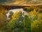 An aerial view of the Catawba river with a train trestle in the background.