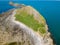 Aerial view of a causeway connecting to an island at low tide Worm`s Head, Rhossili, Wales