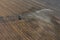 Aerial view about center pivot irrigation system spraying crops.