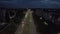 Aerial view of the central double road and the panorama of the city at night with the industrial sector and residential