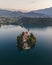 Aerial view of Cerkev Marijinega, a Catholic Church on a small island in the middle of Bled Lake at sunrise, Upper Carniola,