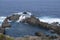 Aerial view on Charco del Viento natural pool in black lava rocks on Tenerife, Canary islands, Spain