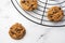 Aerial view of chocolate cookies on black grid, on white marble table, selective focus, horizontal,