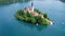 Aerial view of Church of Assumption of Mary in center of lake Bled, Slovenia