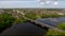 Aerial view of the city bridge with a reflection of clouds.