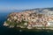 Aerial view the city of Kavala in northern Greek, ancient aqueduct Kamares, homes and medieval city wall