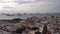 Aerial view of the city of Las Palmas with the roofs of houses and the cathedral at sunset and boats on the horizon