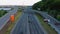 Aerial view of city motorways with cars and trees.