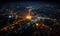 Aerial view of a city at night showcasing the intricate network of illuminated streets and highways, embodying the pulsating