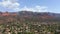 Aerial view of the city of Sedona, Arizona with red rocks surrounding the valley