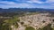 Aerial view of city of an small city surrounded by mountains.