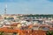 Aerial view of citycape of old town of Prague, with a lot of  rooftops, churches, and the landmark of Television Tower. view from