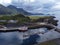 Aerial view of a cityscape of buildings and waterways in Norway, surrounded by natural landscape