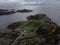 Aerial view of a cityscape of buildings and waterways in Norway, surrounded by natural landscape