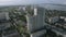 Aerial view of a cityscape and a river far in the distance. Stock footage. Sleeping area, flying over the modern city