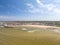 Aerial view of the cityscape and sandy beach surrounded by greenish waters. Margate, Kent, England