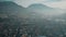 Aerial view of cityscape of Trento and the Alps on a hazy day, Italy