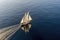 aerial view of classic sailboat gliding on calm sea