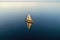 aerial view of classic sailboat gliding on calm sea