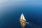 aerial view of a classic sailboat gliding on calm sea